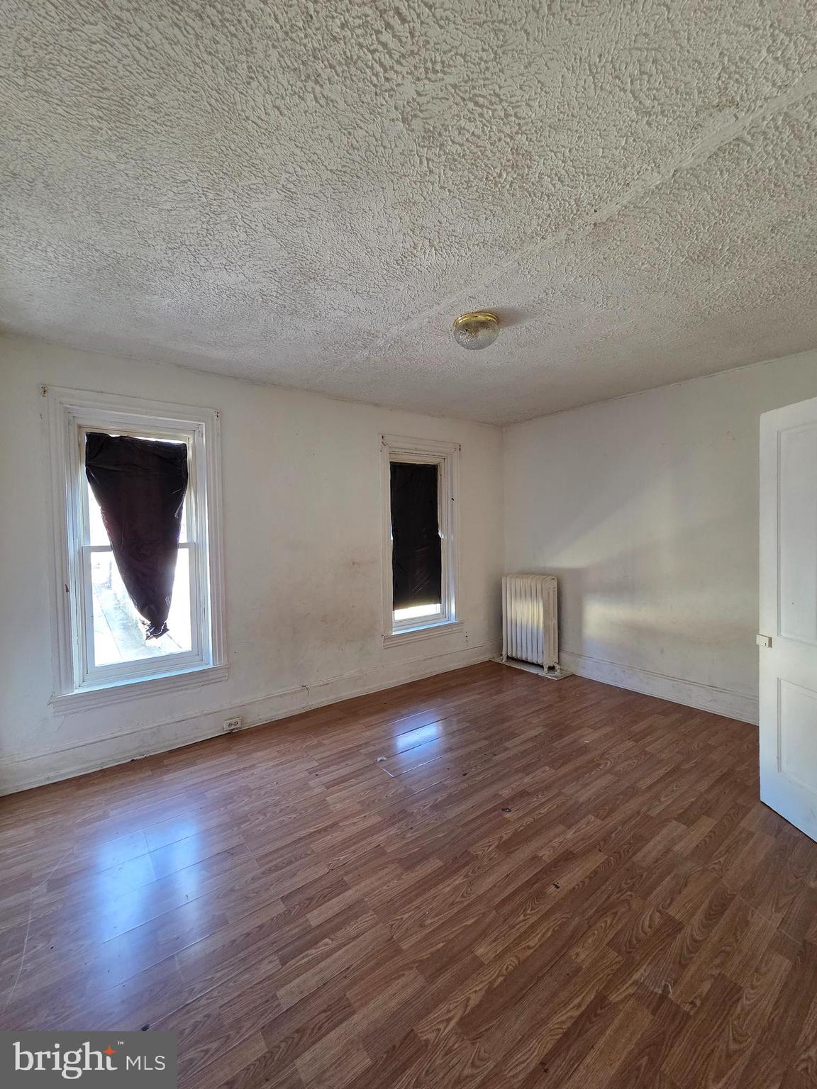 42 Maple Street Reading, PA 19602 - Photo 10 of 21 a view of an empty room with wooden floor and a window