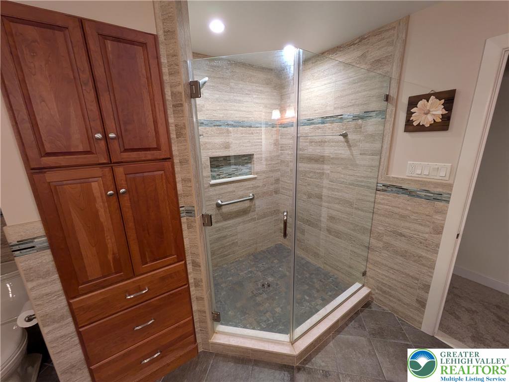 3285 Cherryville Road Northampton, PA 18067 - Photo 23 of 51 Tiled walls and a glass door frame this modern walk-in shower.