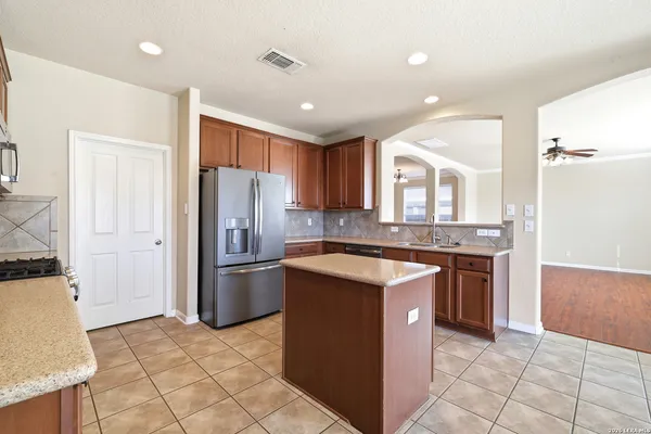 a kitchen with a refrigerator sink and stove