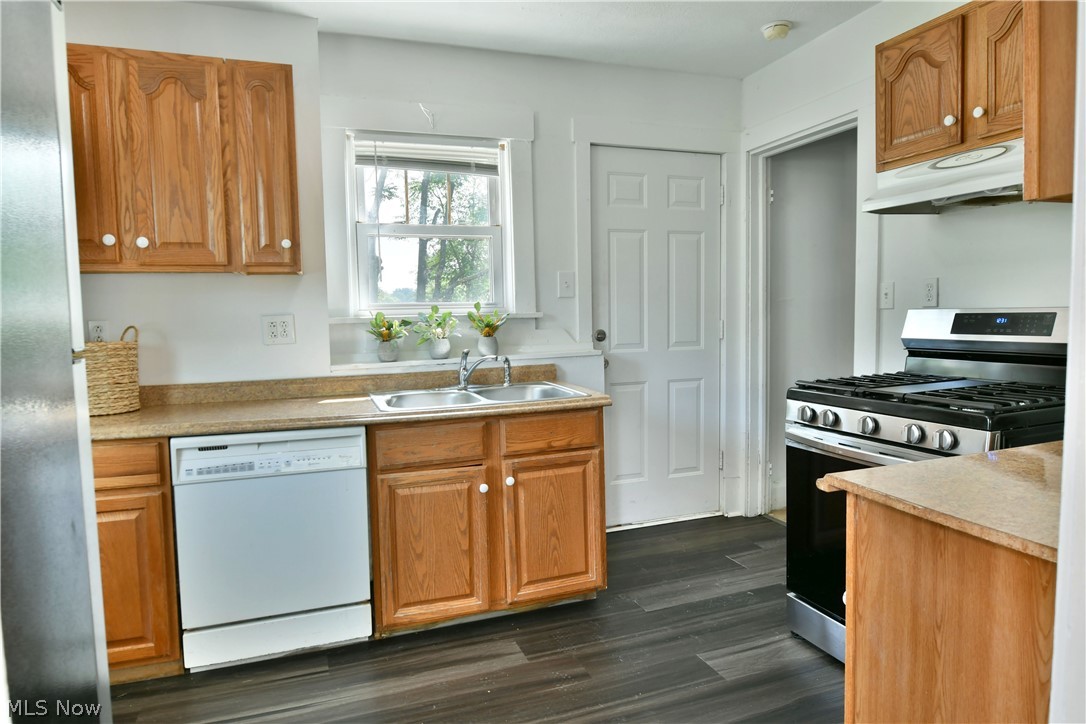 3617 South Main Street Mineral Ridge, OH 44440 - Photo 17 of 34 Kitchen with stainless steel appliances, dark wood-type flooring, and sink