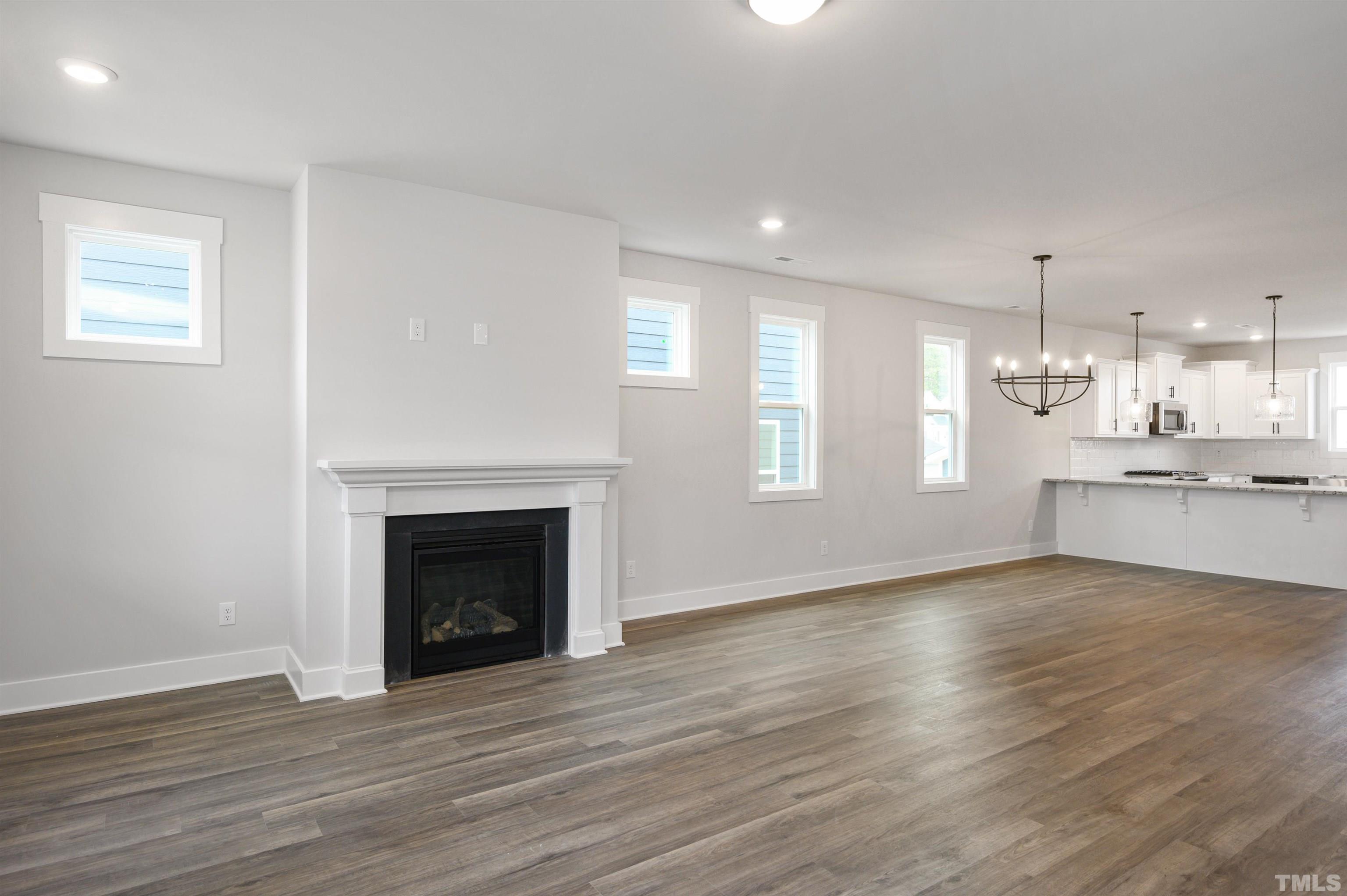 517 Friendship Chapel Road, Unit HVA0055 Wake Forest, NC 27587 - Photo 32 of 58 a view of an empty room with wooden floor and a window