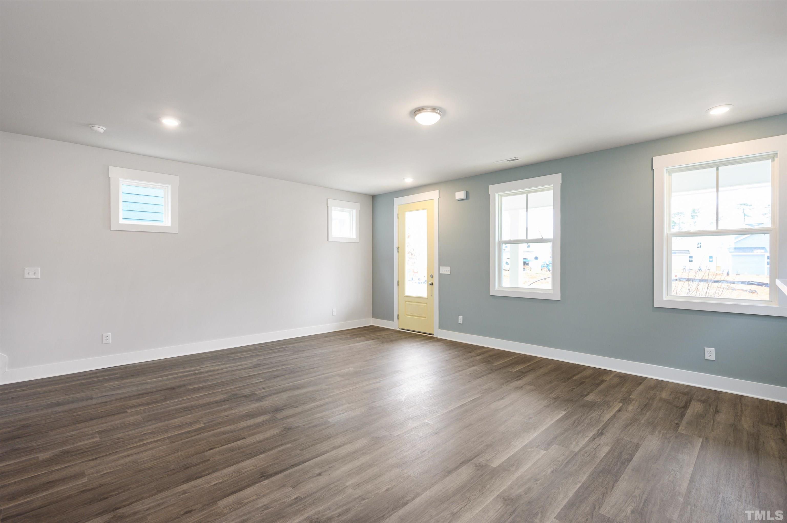 517 Friendship Chapel Road, Unit HVA0055 Wake Forest, NC 27587 - Photo 34 of 58 a view of an empty room with wooden floor and window