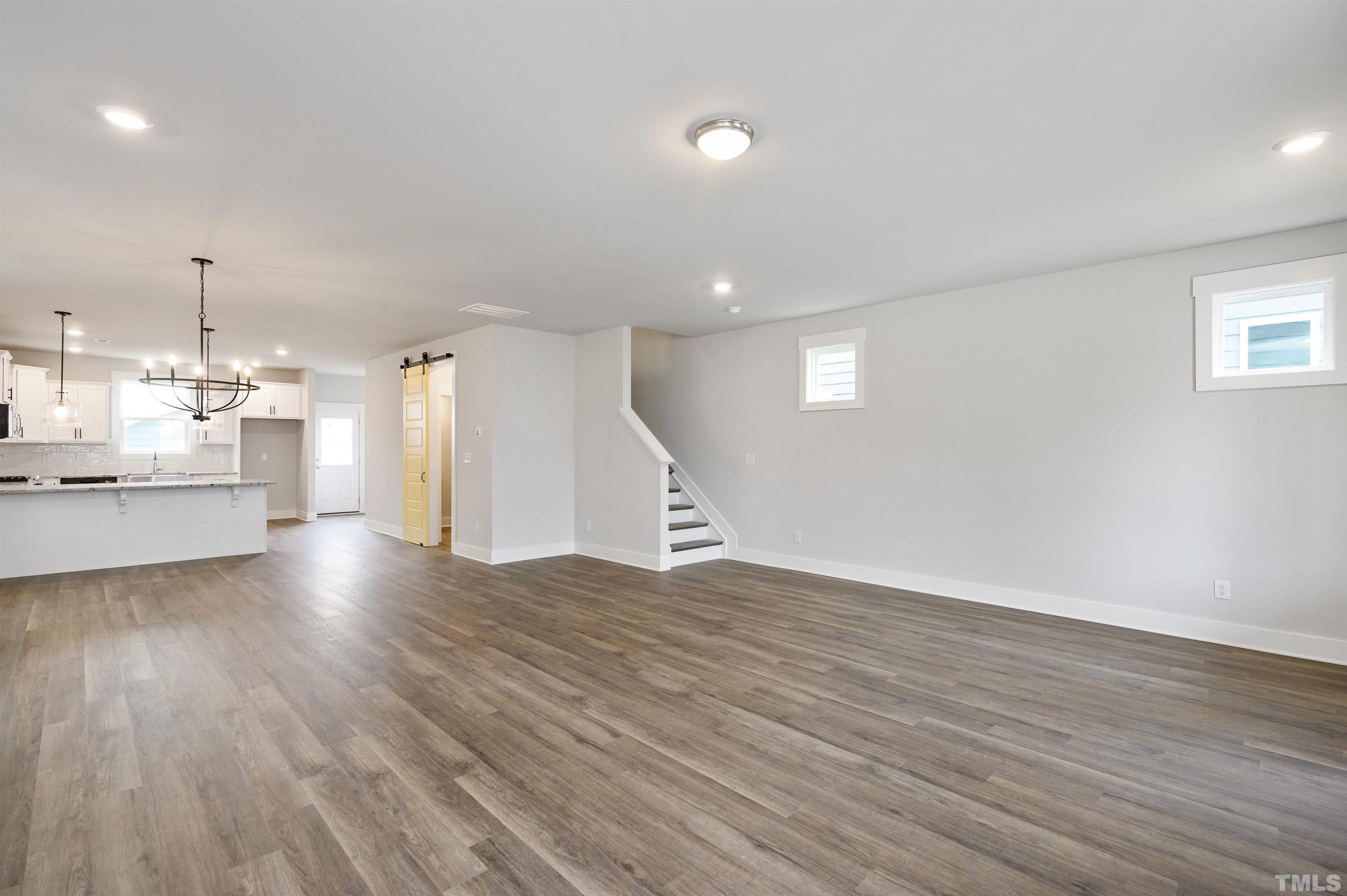 517 Friendship Chapel Road, Unit HVA0055 Wake Forest, NC 27587 - Photo 35 of 58 a view of a room with wooden floor and windows