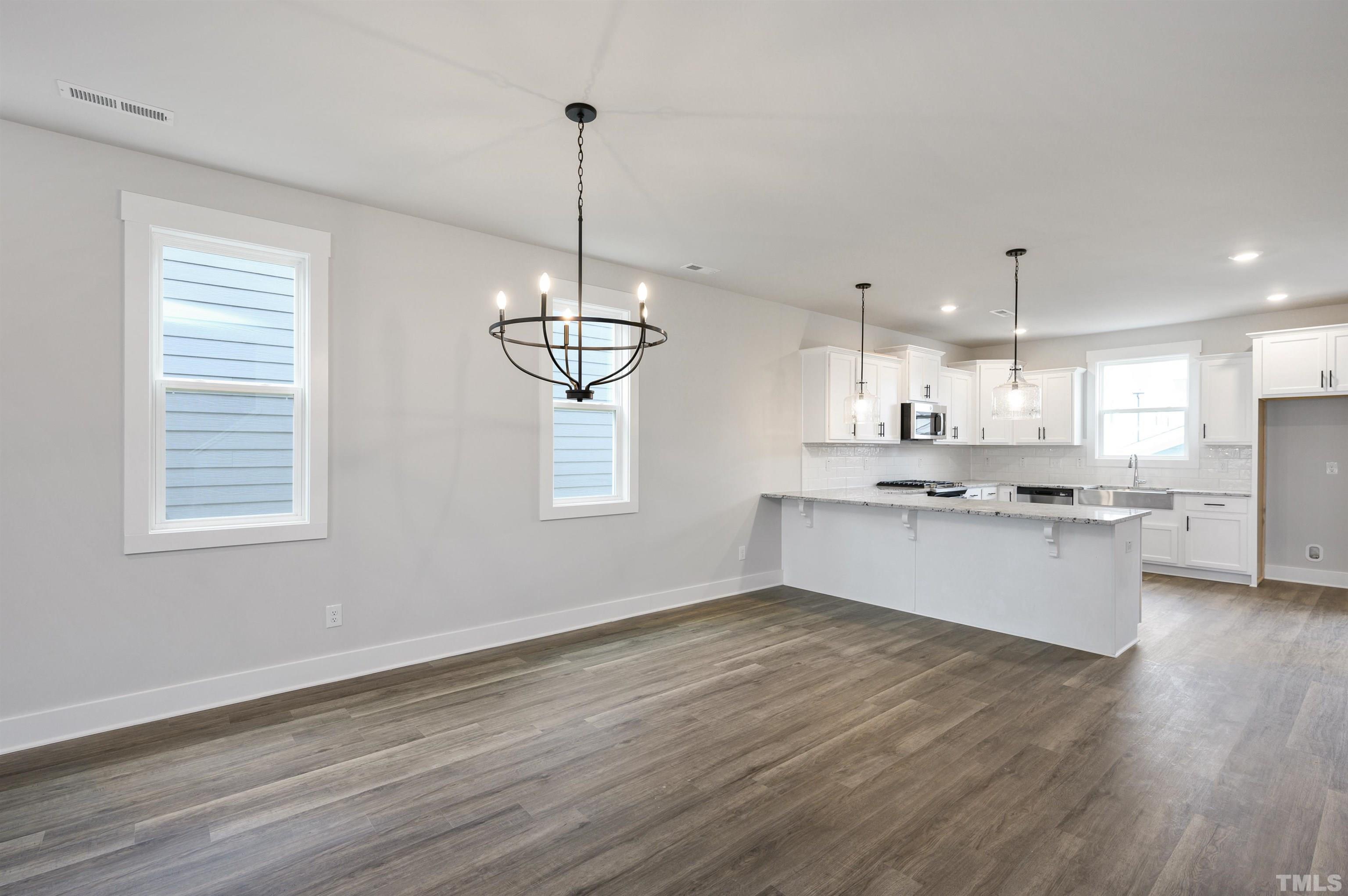 517 Friendship Chapel Road, Unit HVA0055 Wake Forest, NC 27587 - Photo 36 of 58 a large kitchen with a counter space a sink stainless steel appliances and cabinets