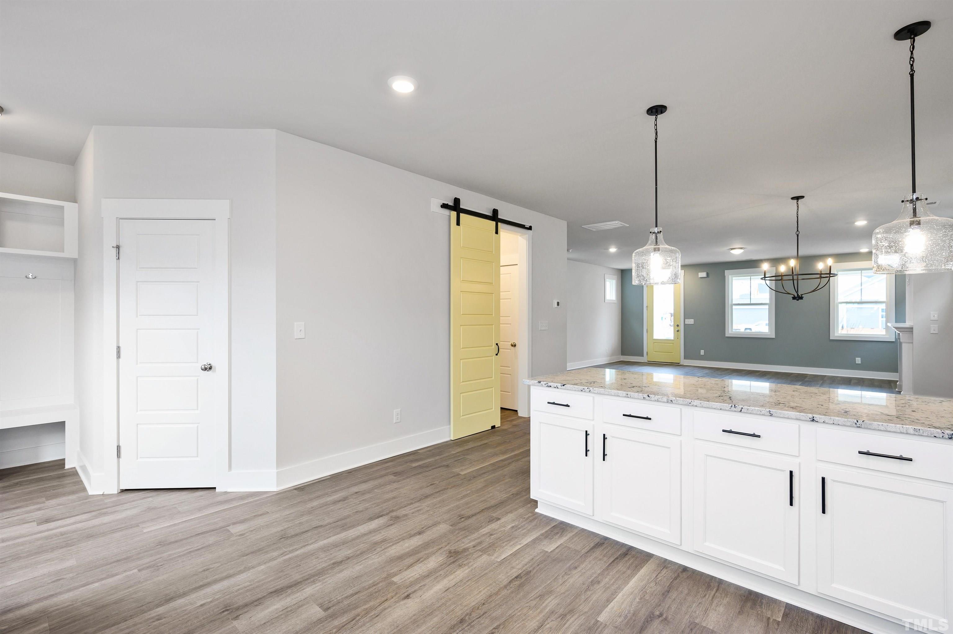 517 Friendship Chapel Road, Unit HVA0055 Wake Forest, NC 27587 - Photo 39 of 58 a kitchen with stainless steel appliances granite countertop a sink a stove a refrigerator and white cabinets with wooden floor