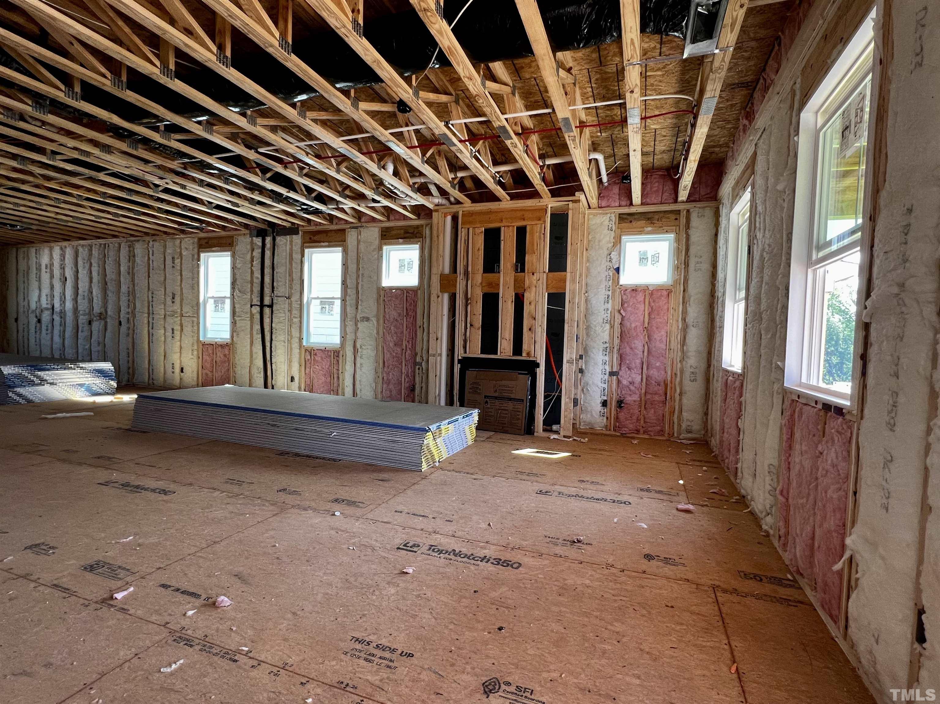 517 Friendship Chapel Road, Unit HVA0055 Wake Forest, NC 27587 - Photo 4 of 58 an empty room with wooden floor and windows