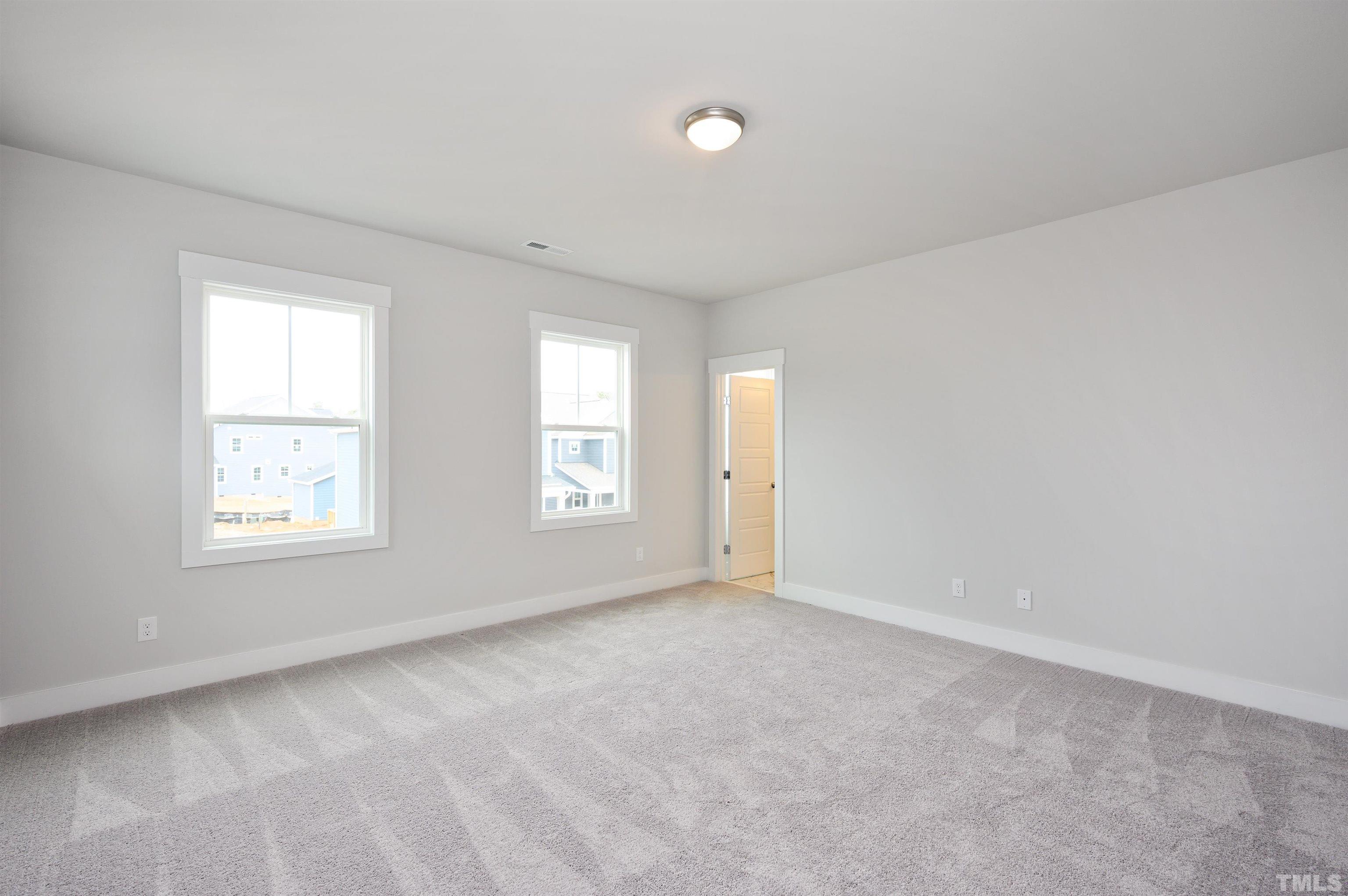 517 Friendship Chapel Road, Unit HVA0055 Wake Forest, NC 27587 - Photo 43 of 58 an empty room with windows