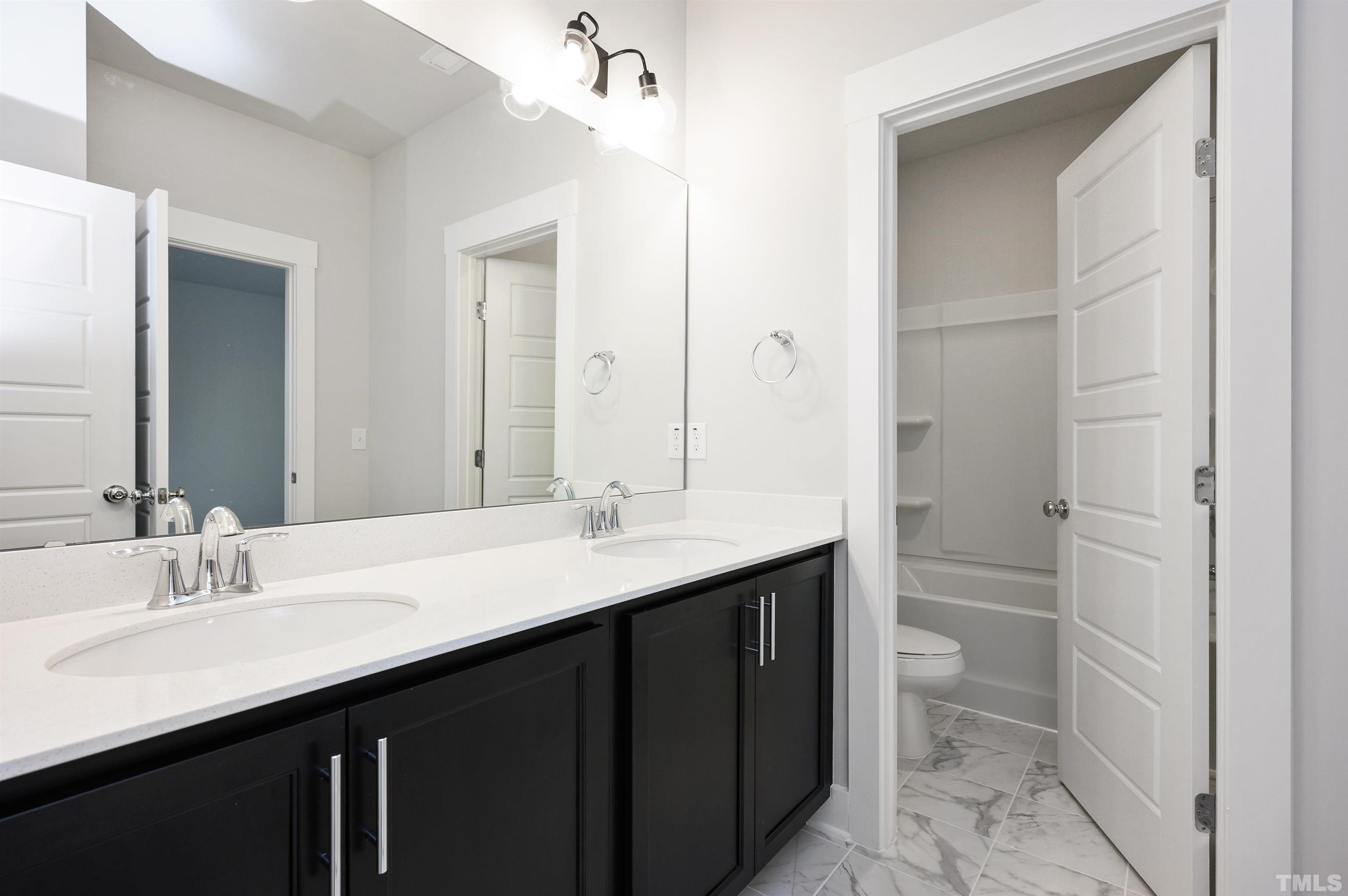 517 Friendship Chapel Road, Unit HVA0055 Wake Forest, NC 27587 - Photo 47 of 58 a bathroom with a sink a toilet and a mirror
