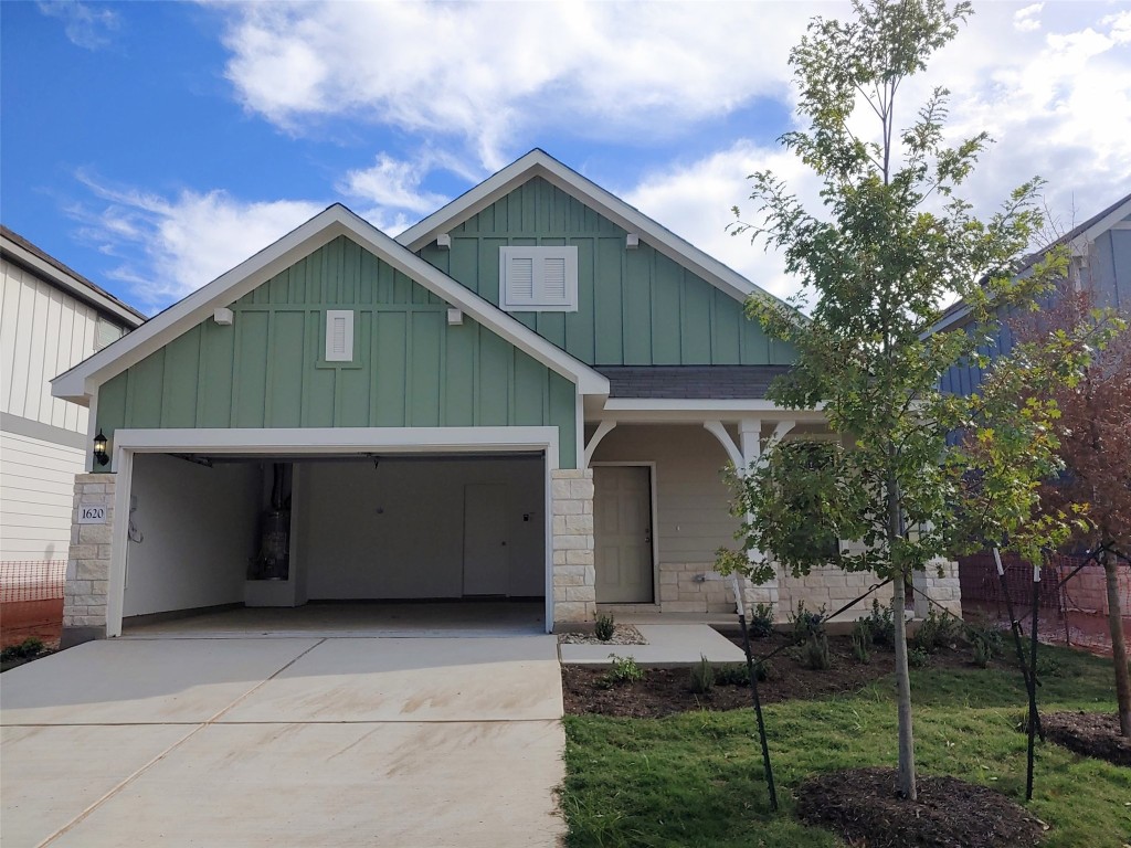 a front view of a house with plants