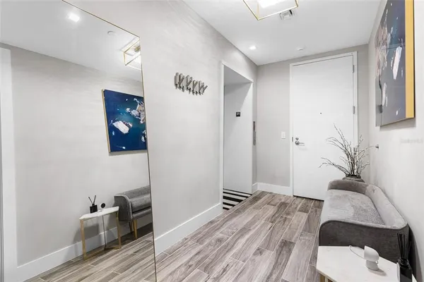 a large white kitchen with kitchen island a large counter top space a sink stainless steel appliances and cabinets
