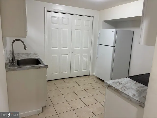 a view of a kitchen with a sink dryer and cabinets
