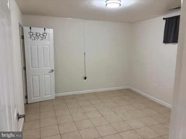 an empty room with windows and cabinet