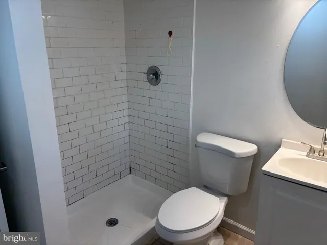 a white toilet sitting next to a bath tub