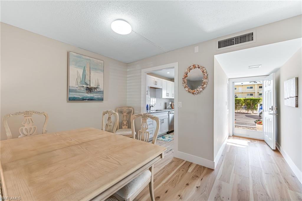 1021 3rd Street South, Unit 110 Naples, FL 34102 - Photo 12 of 30 a bedroom with a bed and a walk in closet