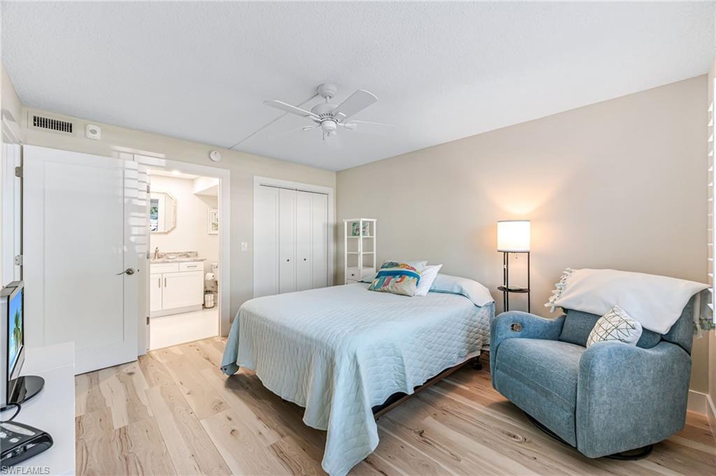 1021 3rd Street South, Unit 110 Naples, FL 34102 - Photo 16 of 30 a bedroom with a bed couch and a window