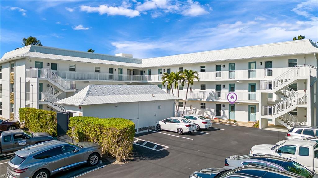 1021 3rd Street South, Unit 110 Naples, FL 34102 - Photo 3 of 30 a view of a patio with table and chairs and potted plants