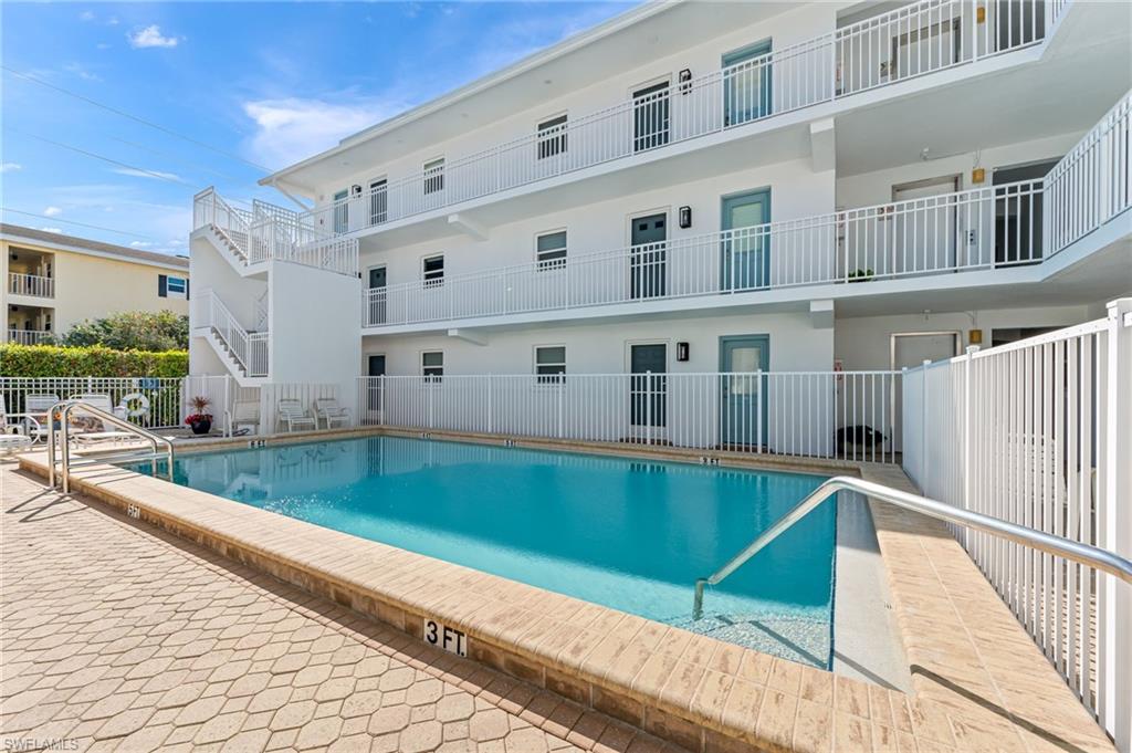 1021 3rd Street South, Unit 110 Naples, FL 34102 - Photo 5 of 30 a balcony with table and chairs