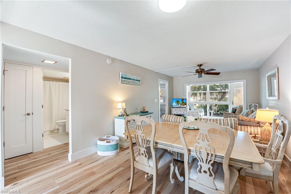 1021 3rd Street South, Unit 110 Naples, FL 34102 - Photo 7 of 30 a view of a dining room with furniture window and wooden floor