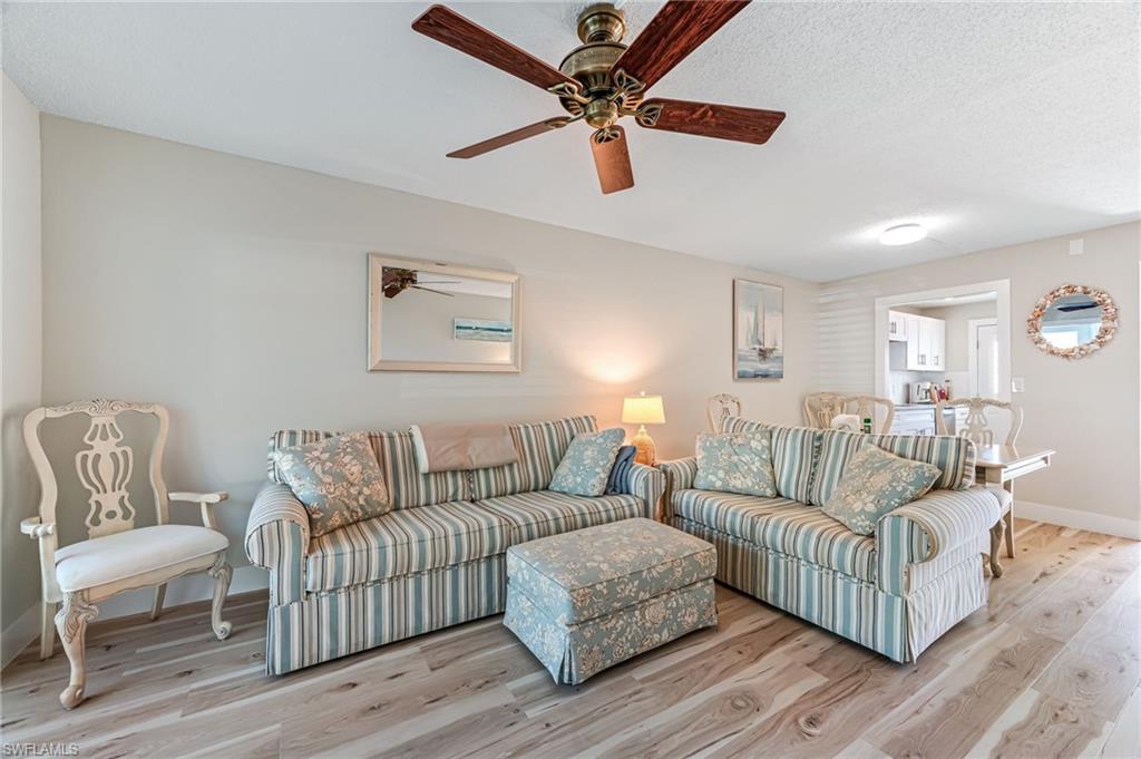1021 3rd Street South, Unit 110 Naples, FL 34102 - Photo 9 of 30 a living room with furniture and a wooden floor