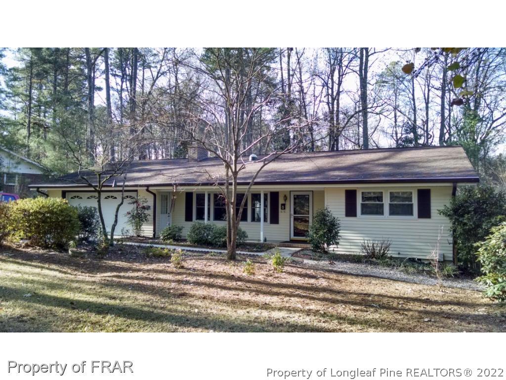 166 Boiling Spring Circle Southern Pines, NC 28387 - Photo 1 of 19 a front view of a house with a garden