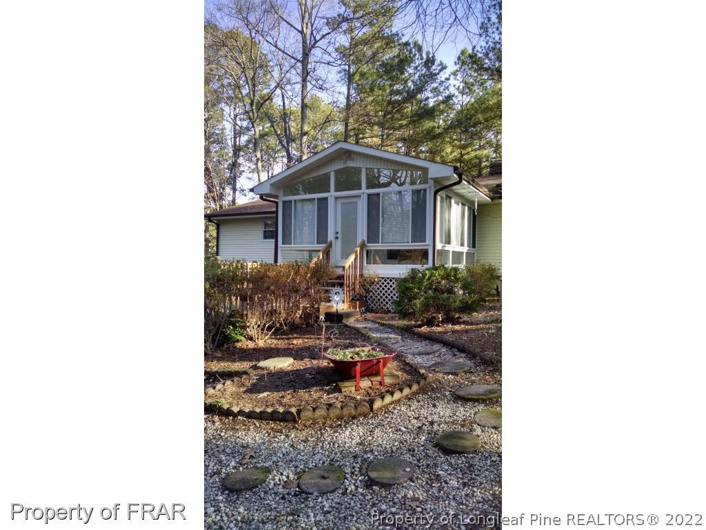 166 Boiling Spring Circle Southern Pines, NC 28387 - Photo 2 of 19 a view of a small yard in front of a house