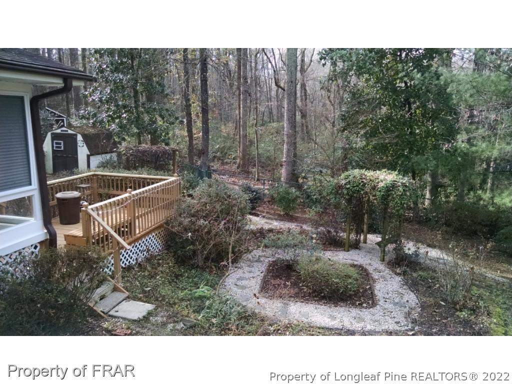 166 Boiling Spring Circle Southern Pines, NC 28387 - Photo 7 of 19 a backyard of a house with a yard and outdoor seating