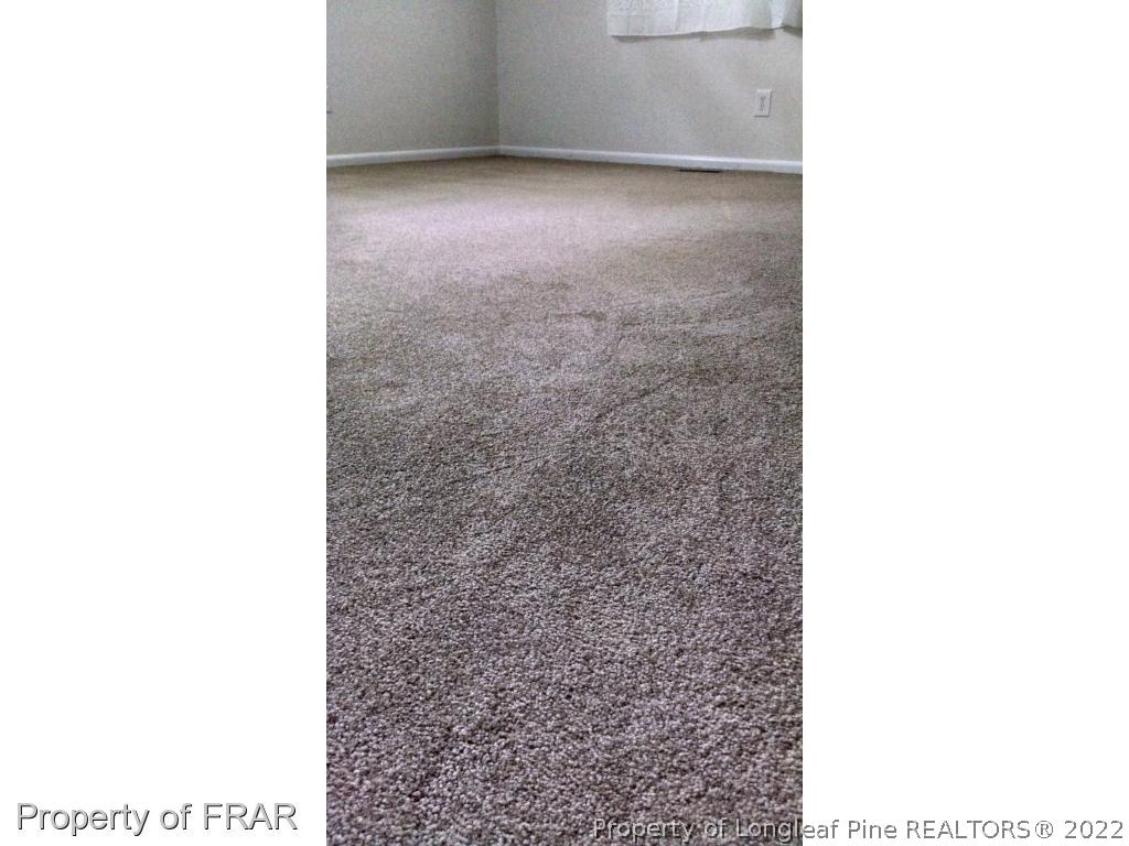 166 Boiling Spring Circle Southern Pines, NC 28387 - Photo 9 of 19 a view of an empty room with wooden floor