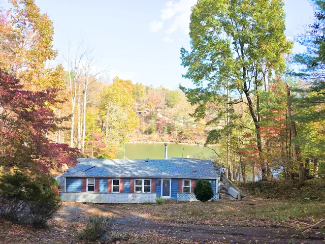 a view of a big house with large trees
