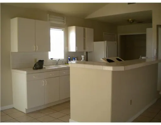 a room with sink washer and dryer