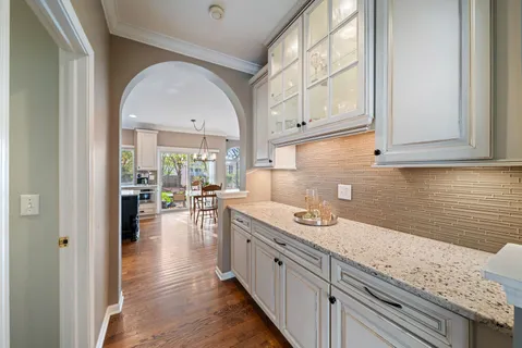 a kitchen with a sink a stove and cabinets