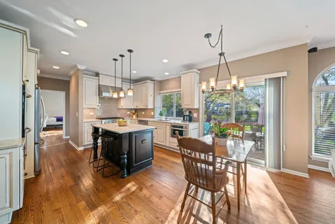 a large kitchen with a table and chairs