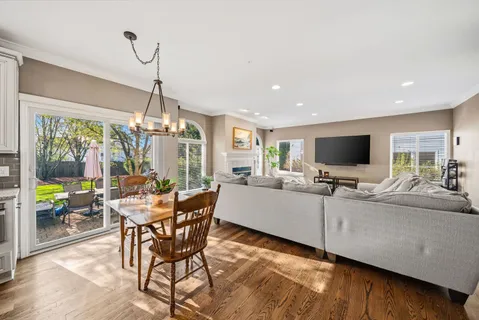 a living room with furniture a flat screen tv and a large window