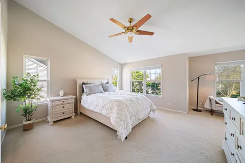 a spacious bedroom with a bed and a large window