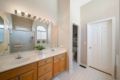 a spacious bathroom with a double vanity sink mirror and