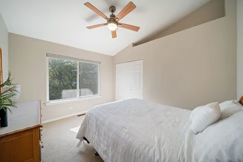 a bedroom with a large bed and a window