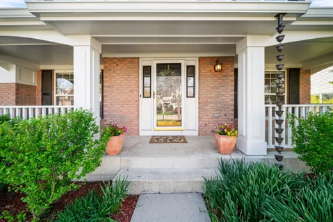 a front view of a house with outdoor seating and plants
