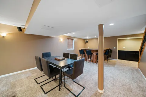 a dining room with furniture and a chandelier
