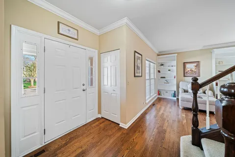 a view of entryway with wooden floor and stairs