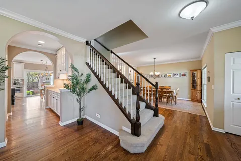 a view of entryway and hall with wooden floor