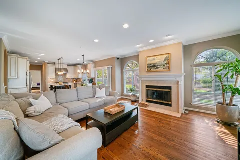 a living room with furniture fireplace and a large window