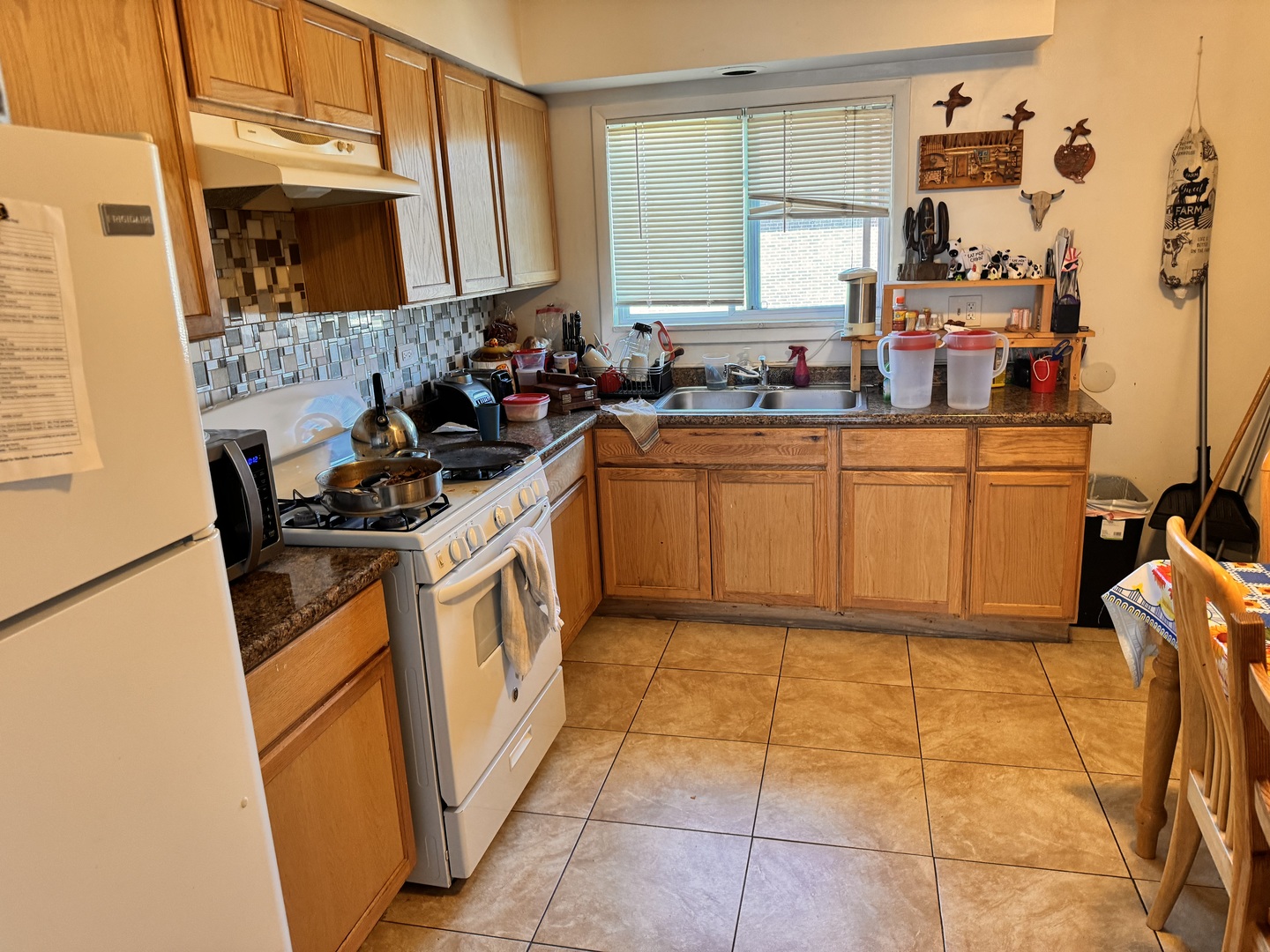 9350 Golf Road Des Plaines, IL 60016 - Photo 20 of 23 a kitchen with stainless steel appliances granite countertop a stove a sink and a refrigerator