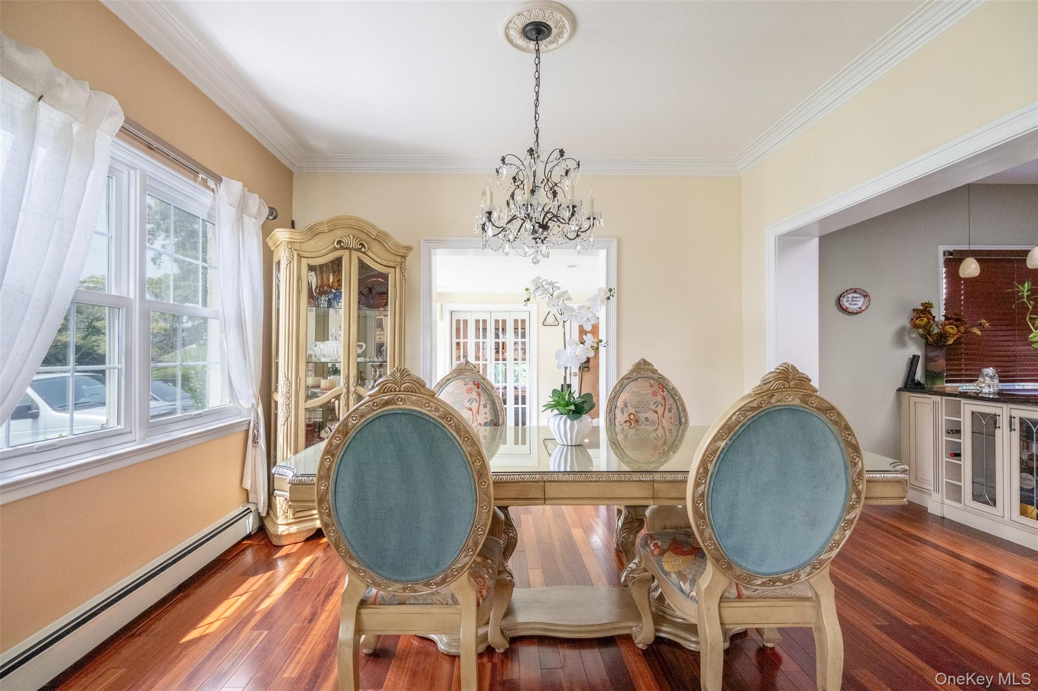 982 Split Rock Road Pelham, NY 10803 - Photo 12 of 33 a living room with furniture chandelier and a mirror