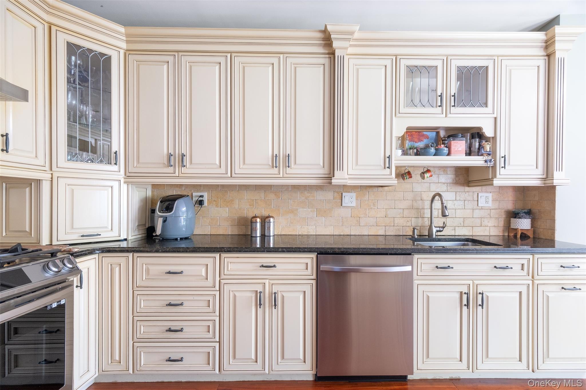 982 Split Rock Road Pelham, NY 10803 - Photo 5 of 33 a kitchen with granite countertop a sink cabinets stainless steel appliances and a window