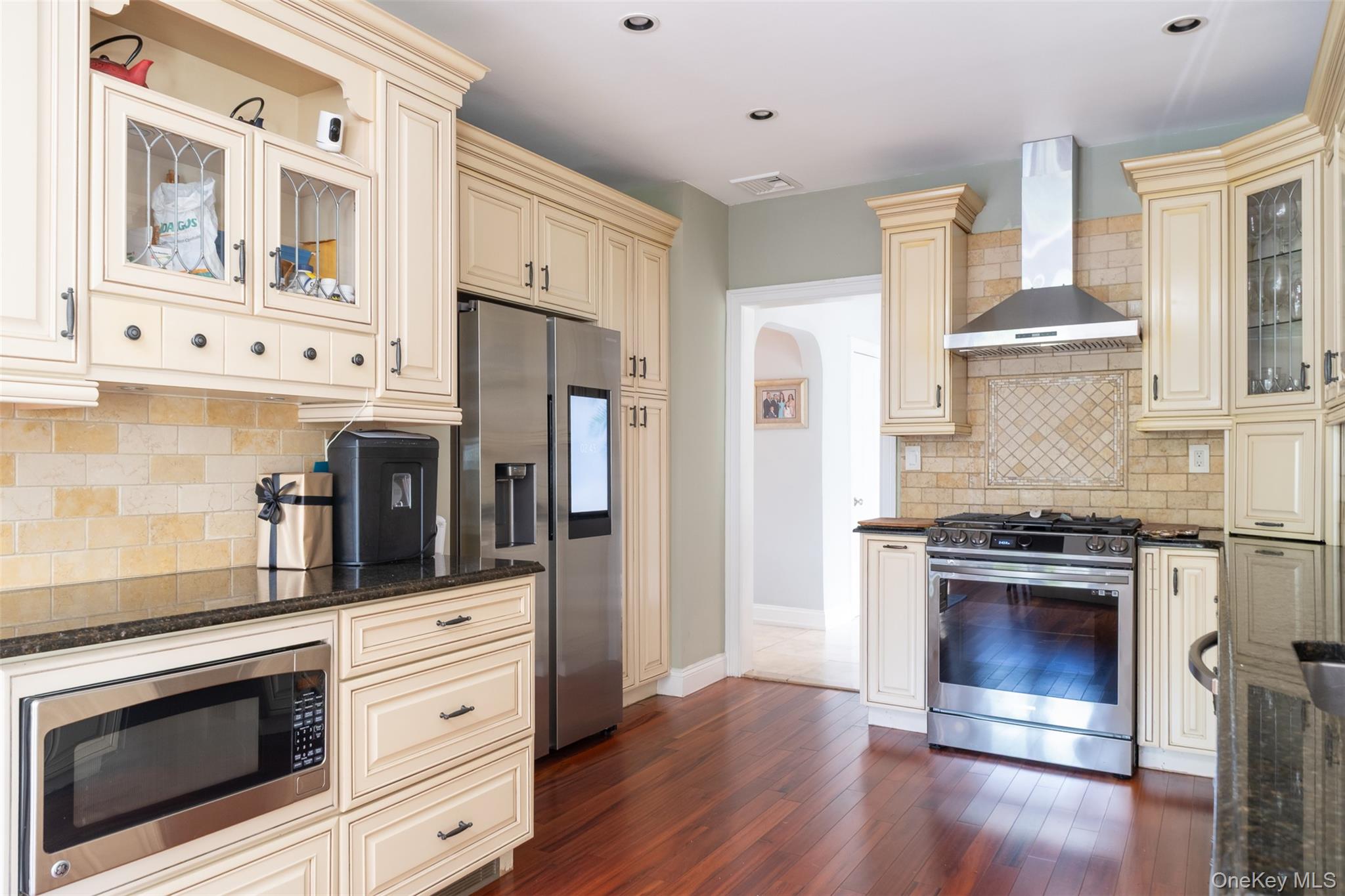 982 Split Rock Road Pelham, NY 10803 - Photo 6 of 33 a kitchen with stainless steel appliances a stove a refrigerator and cabinets
