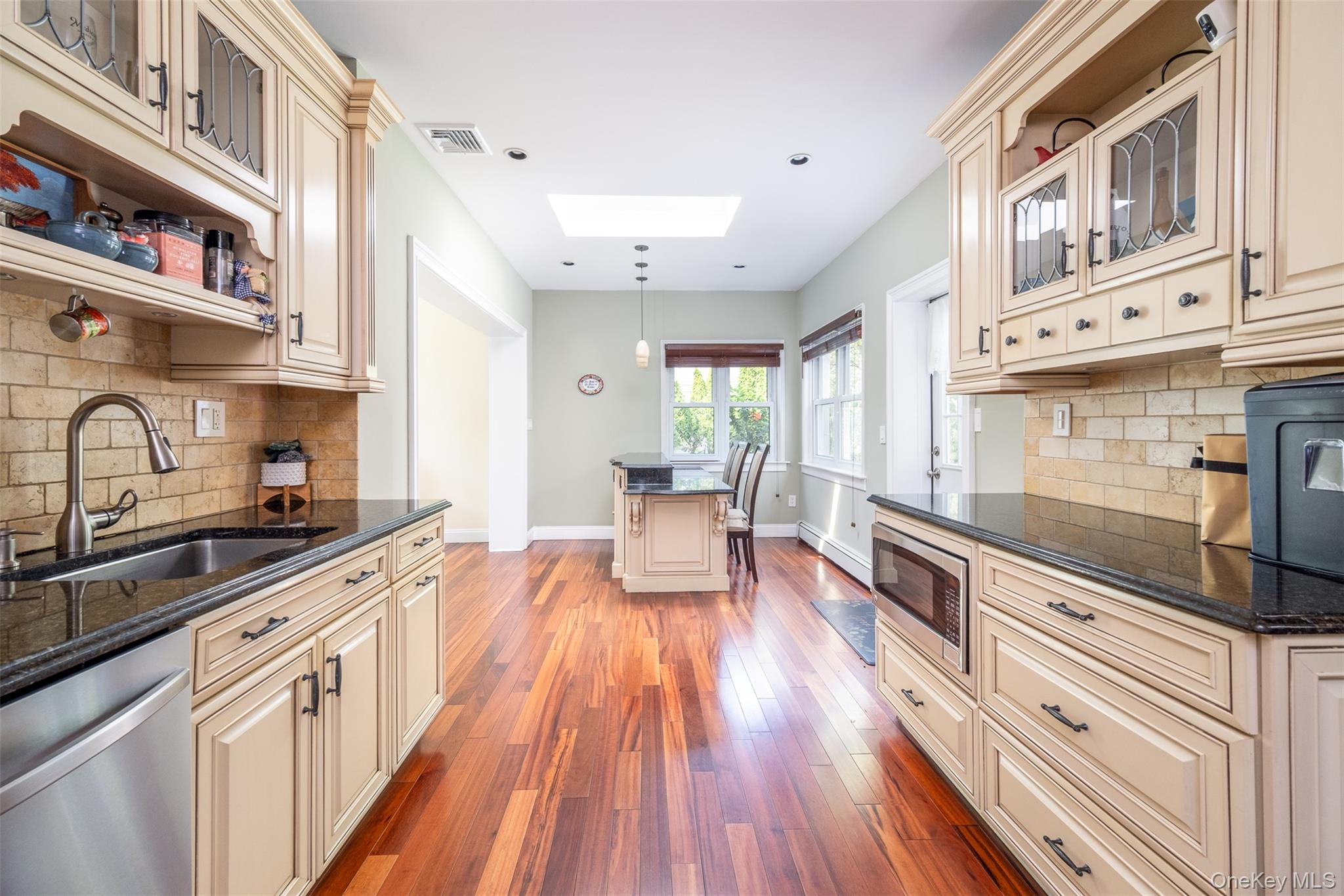 982 Split Rock Road Pelham, NY 10803 - Photo 7 of 33 a large kitchen with stainless steel appliances granite countertop a lot of counter space and wooden floors