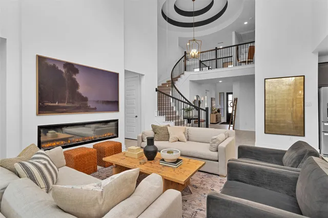 a living room with furniture a rug and white walls