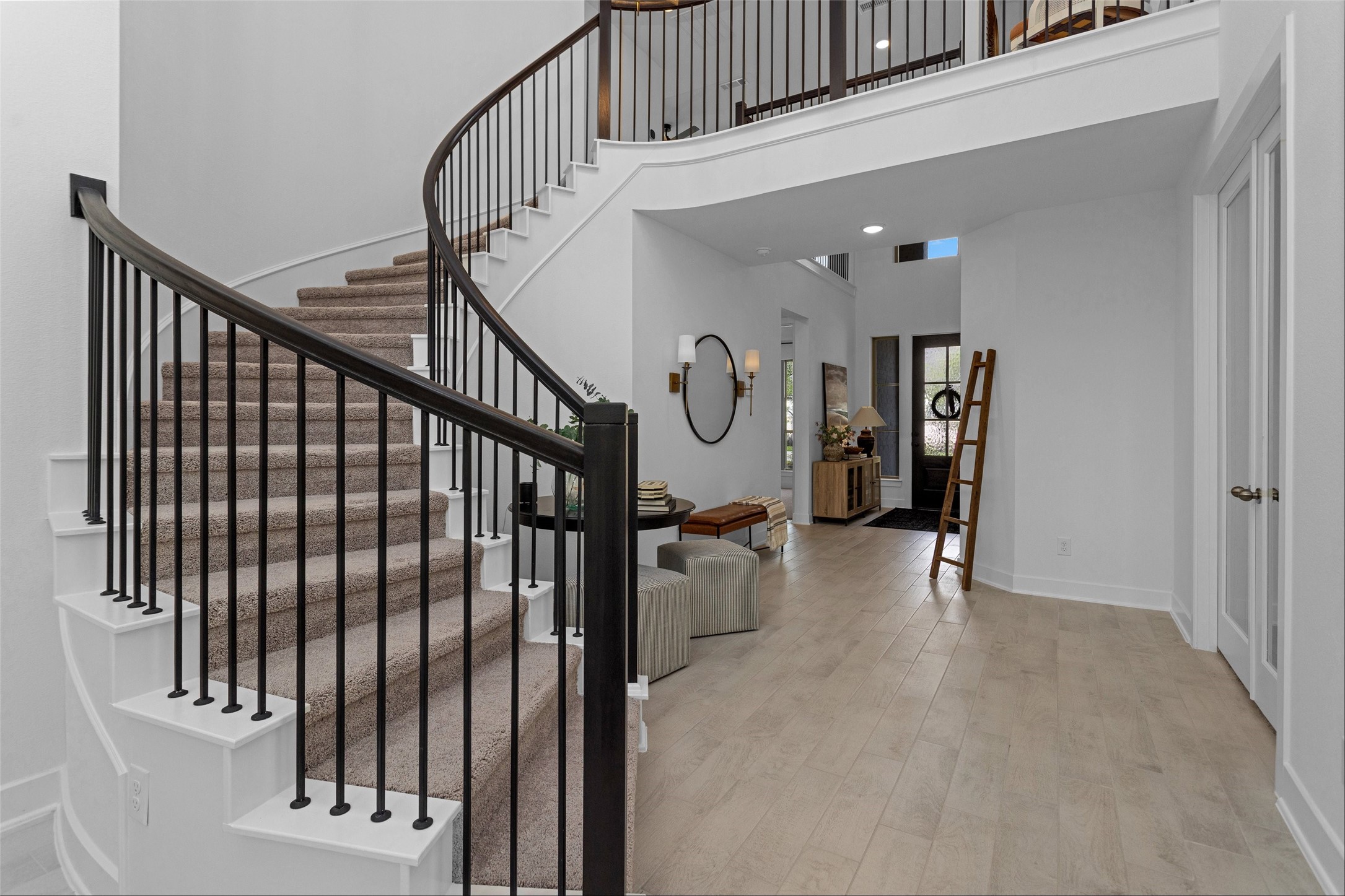 108 Stephens Rdg Lane Montgomery, TX 77316 - Photo 12 of 50 a view of staircase with lots of frames on wall and a window
