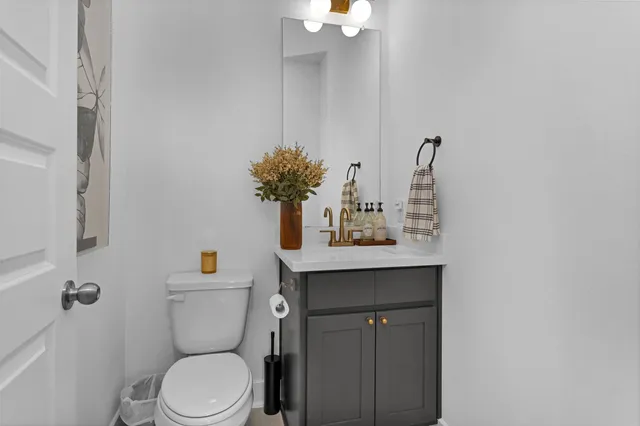 a bathroom with a sink a toilet and mirror