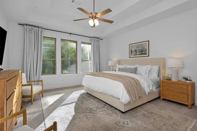 a spacious bedroom with a bed and a large window