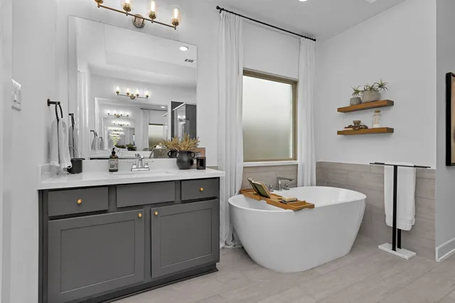 a bathroom with a shower sink and mirror